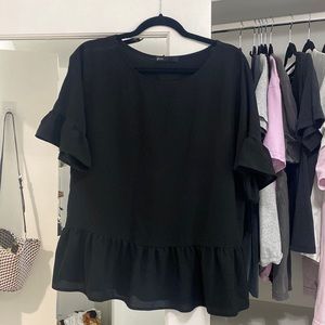Peplum top with ruffle sleeves. Very flattering